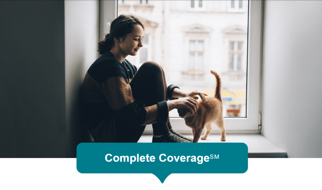 Complete cat insurance coverage by Hartville featuring a woman petting a domestic cat 