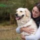 Healthy Paws pet insurance review featuring a woman hugging a labrador retriever