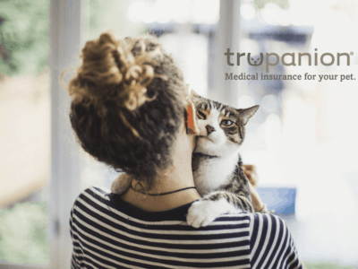 Trupanion Pet Insurance Review featuring a woman hugging a cat