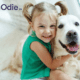 Odie pet insurance review featuring a girl hugging a golden retriever