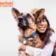 Banfield pet coverage review featuring a woman hugging a German shepherd dog